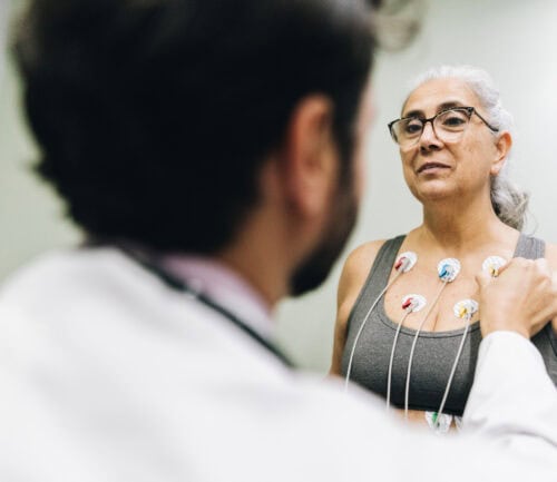 Patient talking with her doctor during a cardiopulmonary stress test on a hospital