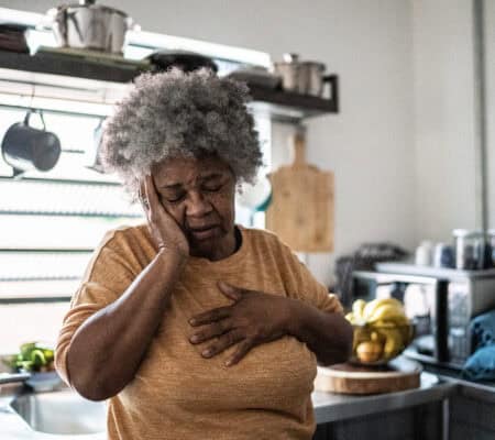 Worried senior woman in the kitchen at home