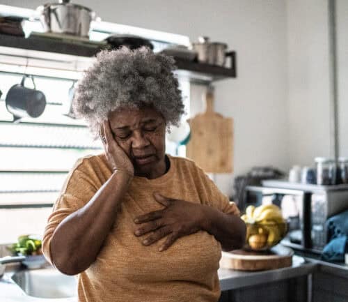Worried senior woman in the kitchen at home