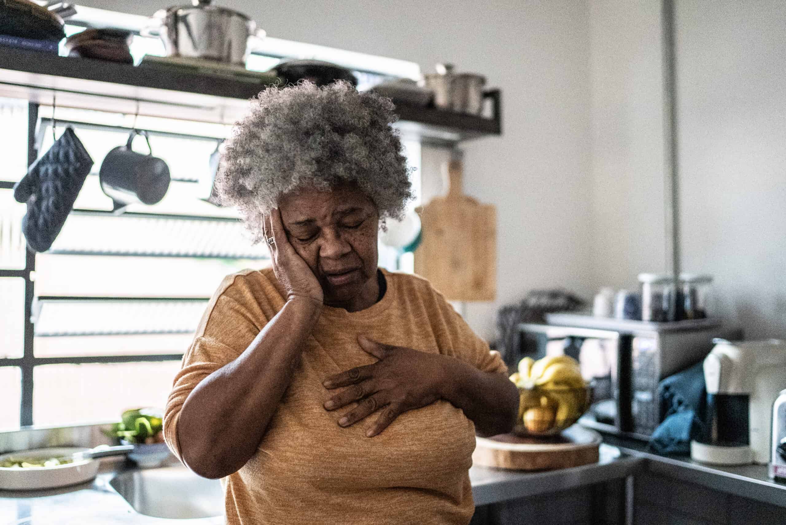 Worried senior woman in the kitchen at home