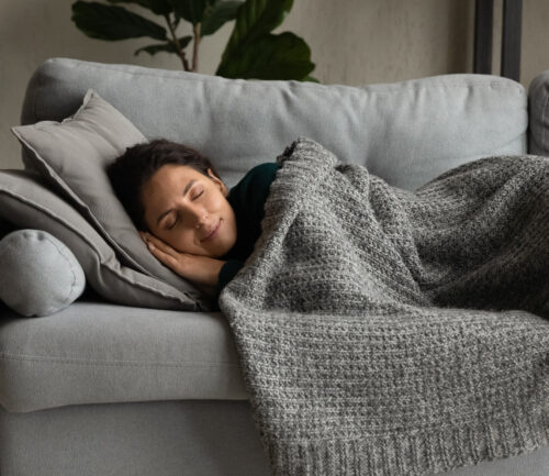 A woman taking a nap on a couch