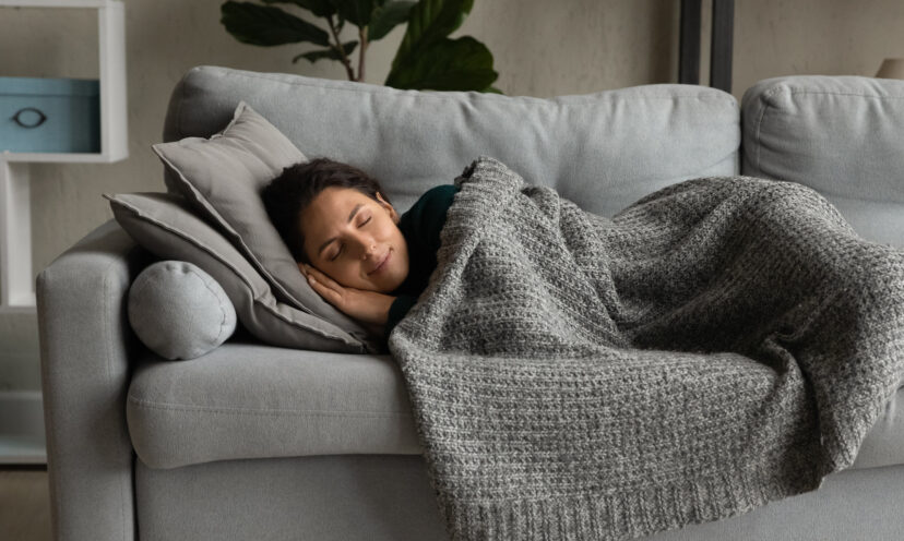 A woman taking a nap on a couch