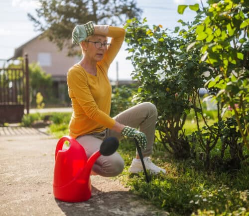 Senior woman is feeling tired while gardening