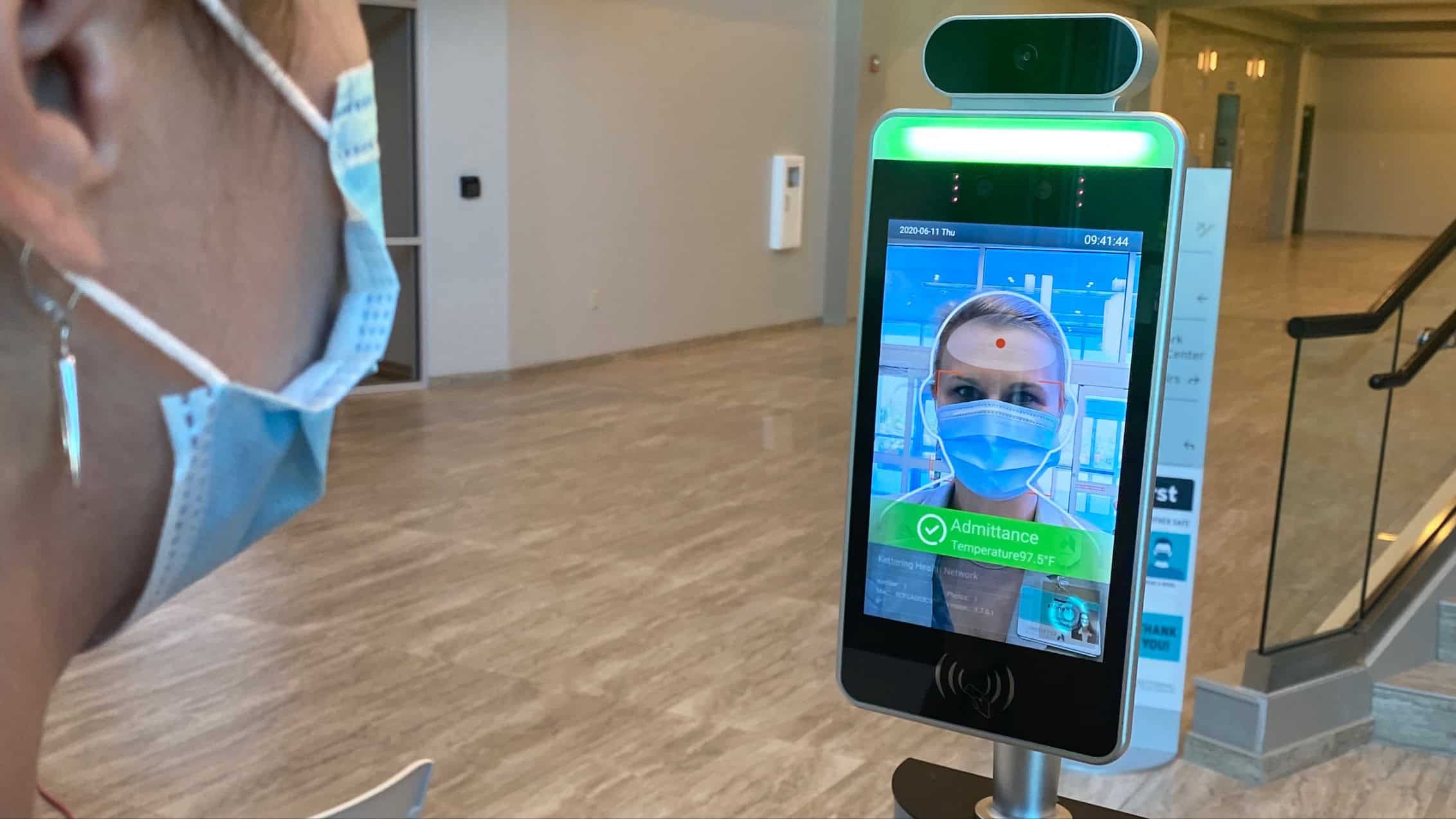 Woman has temperature scanned with ipad