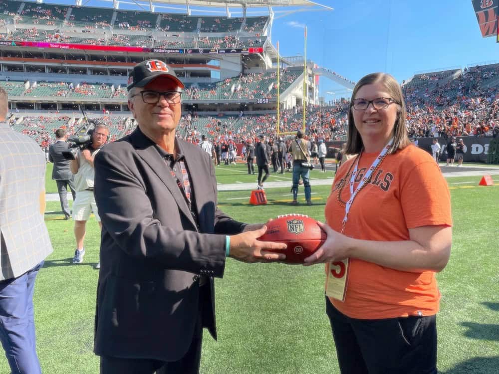 Kelly Long receiving game ball at Bengals game