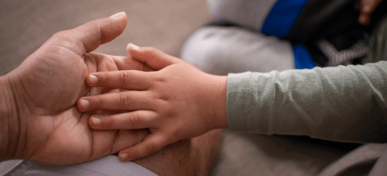 Kid holding parent hand