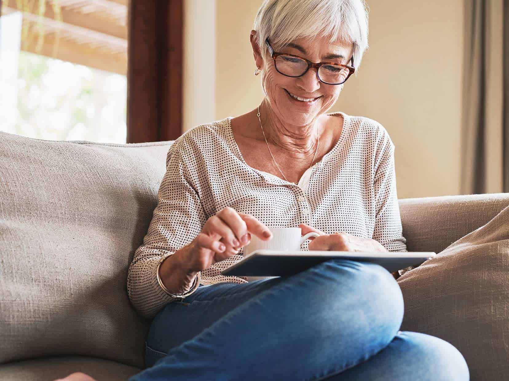 Woman sitting on couch using her ipad