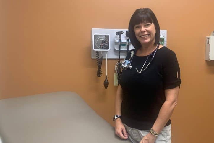 Physician Assistant Lori Zwickel stands in patient room