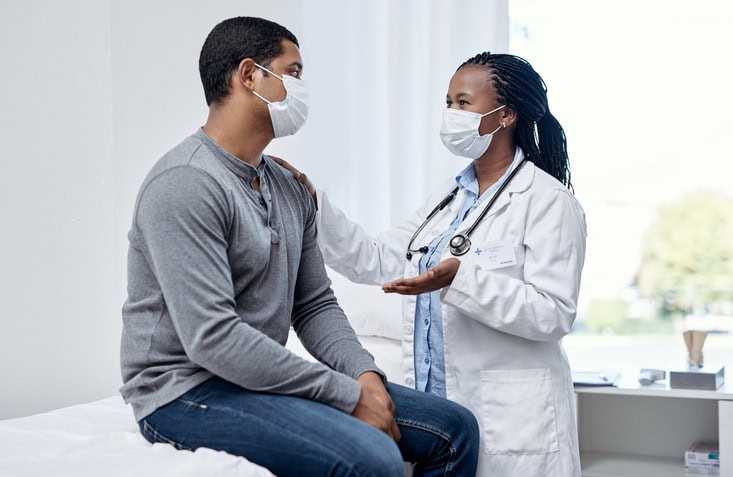 doctor talks with patient during appointment