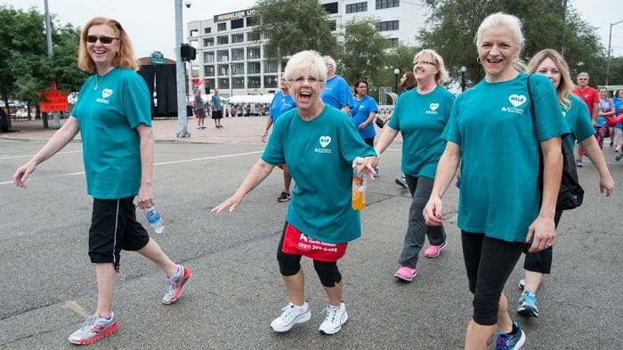 Women walking with water bottles.