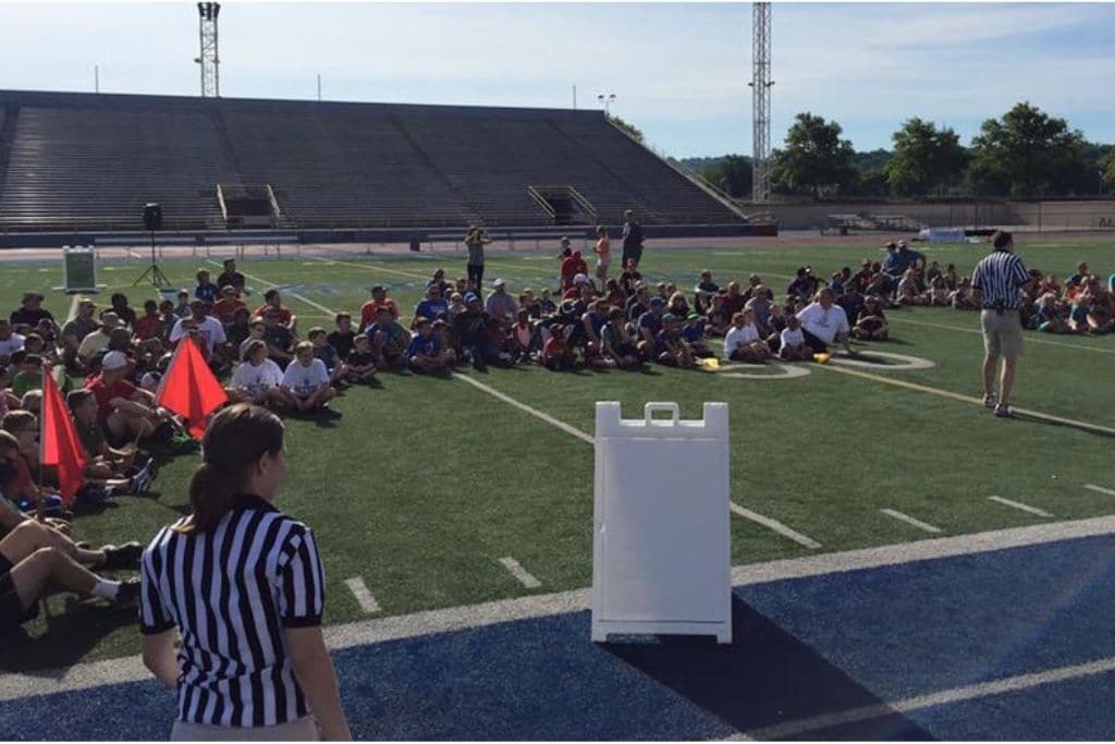 Students sit on football field