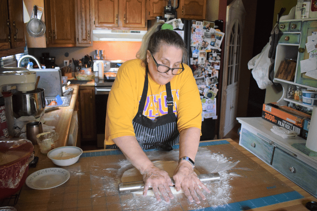 Woman rolls out dough by hand