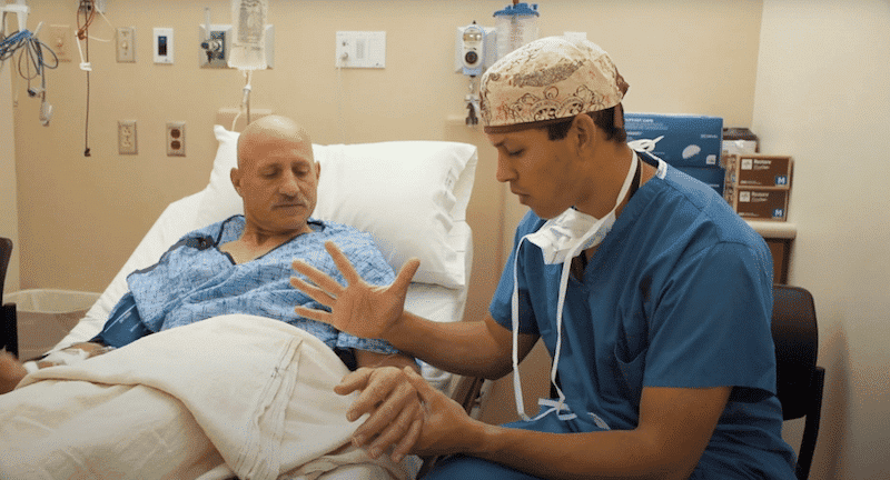 Resident consults with patient before free hand surgery