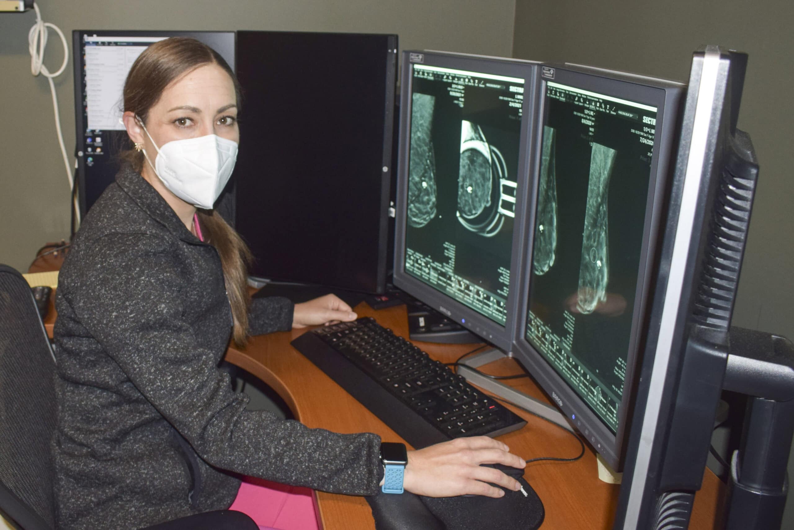Dr. Musser sits at computer reviewing scan