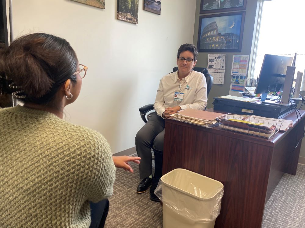 Julie discusses the holidays with a patient.