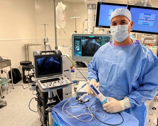 Doctor holds Aquablation Therapy device for prostate health