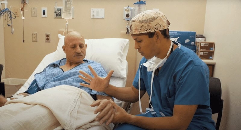 Doctor preps patient for hand surgery