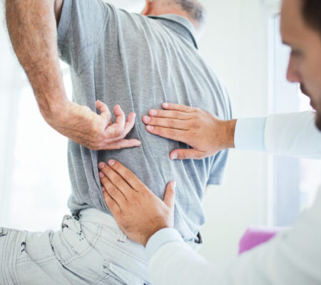 Provider examines patient's back