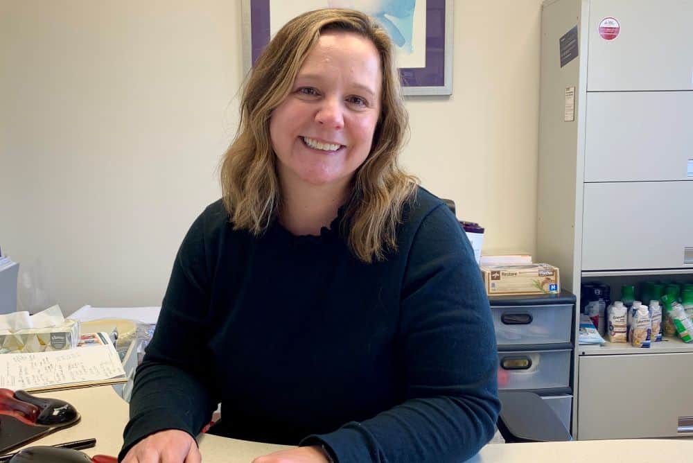 Heather Brown Registered Dietitian smiling at the camera in her office