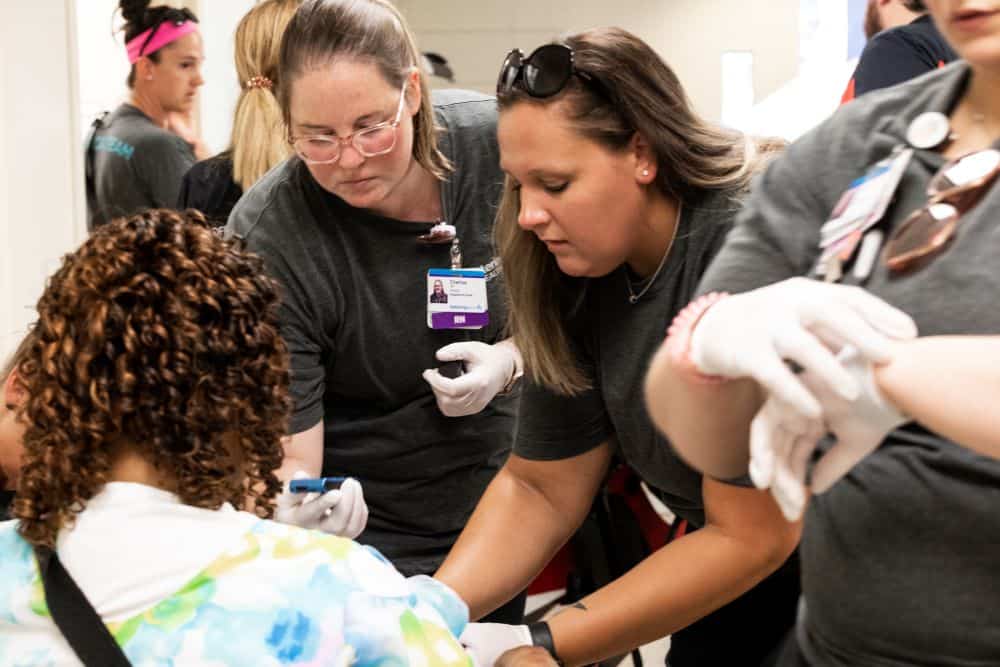 ER nurse checks woman's vitals