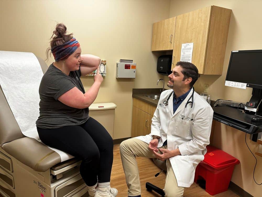 Dr. Jonathan Gaskill explaining wound care to patient