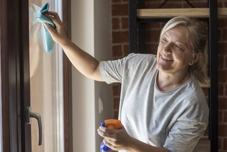 Woman spring cleaning her window