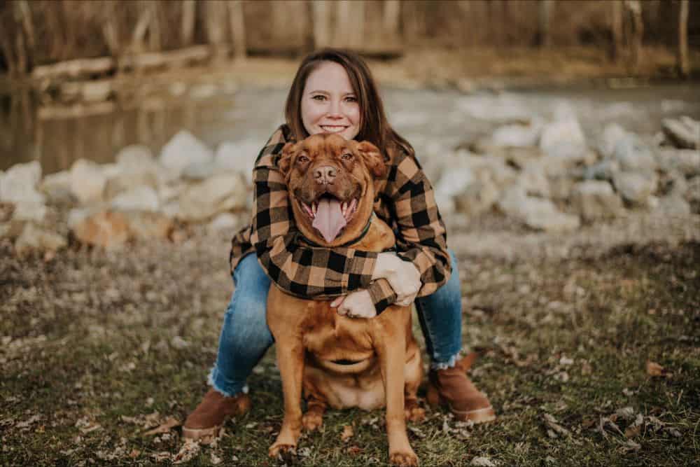 Virginia Chappius hugging her dog outside