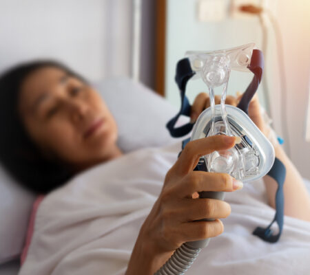 Women holding a cpap machine