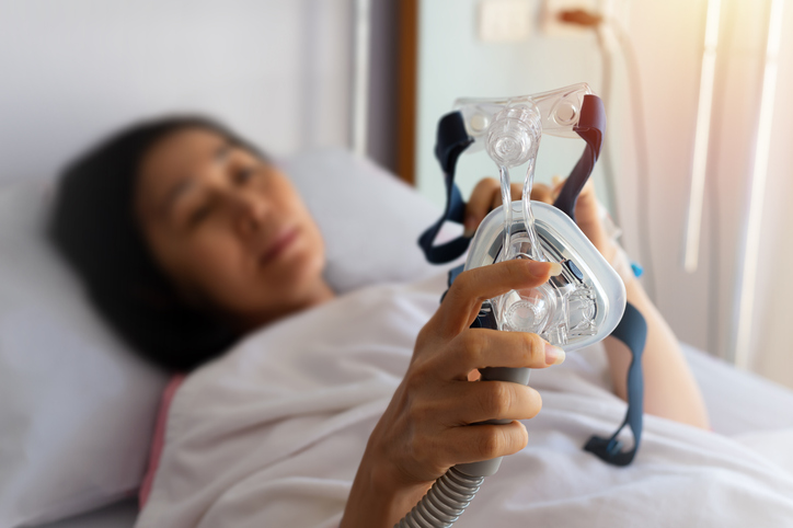 Women holding a cpap machine
