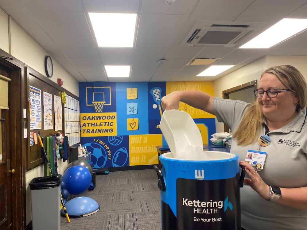 Women getting ice in athletic training center