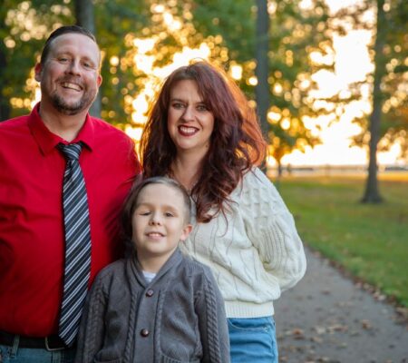 Sarah Peterson, her son, and her husband standing at a park