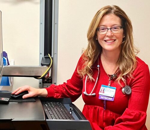 Dr. Deanna Allgeyer smiling at her desk