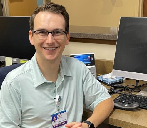 Dr. Joesph King, caffeine subject matter expert, smiling at his desk