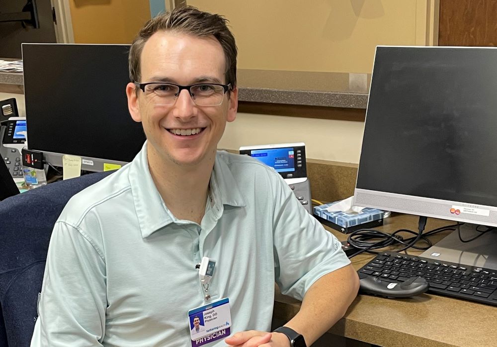 Dr. Joesph King, caffeine subject matter expert, smiling at his desk