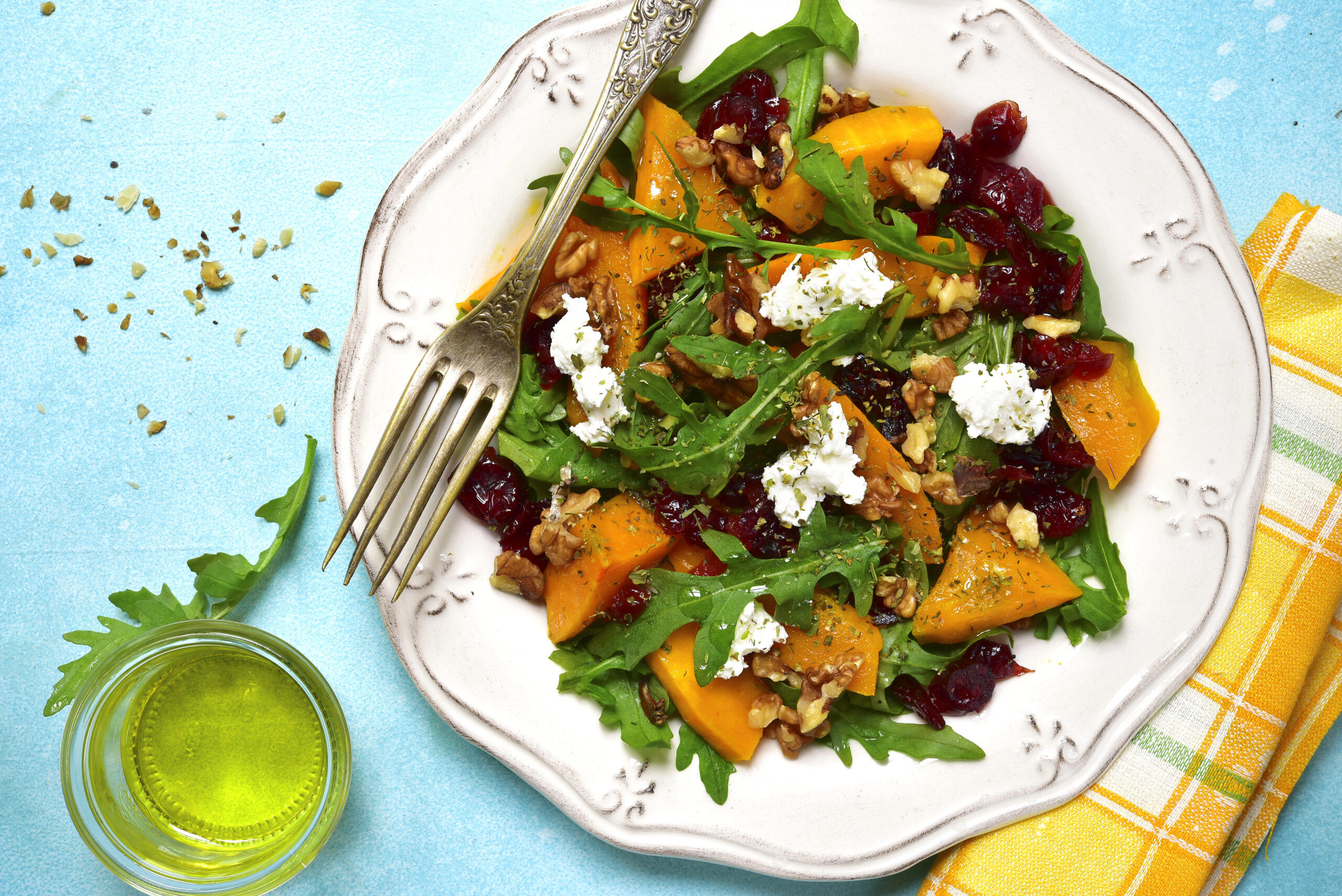 Warm autumn pumpkin salad with dried cranberries,arugula and feta