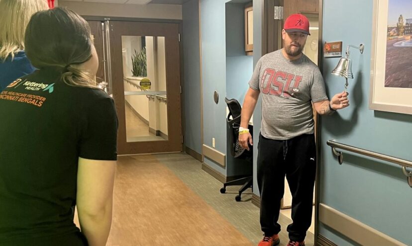 Bill Wooley ringing the inpatient rehabilitation bell at Kettering Health Hamilton