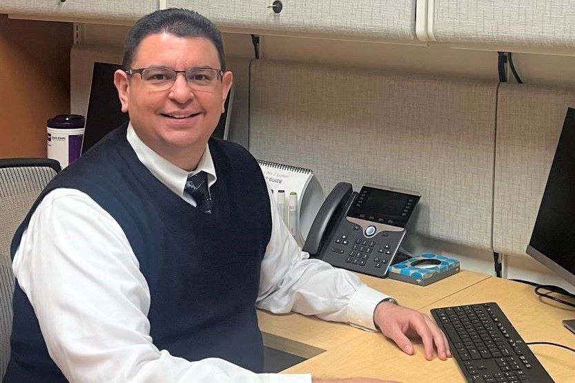 Dr. Carlos Ventura sitting at his desk