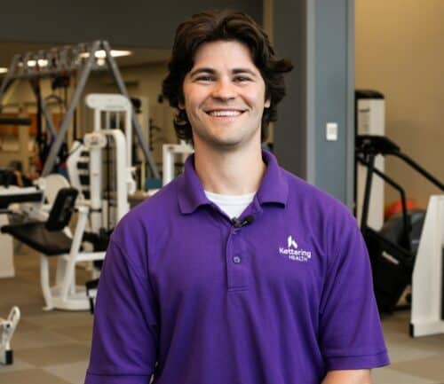 physical therapist Aaron Cingle smiles at camera in gym