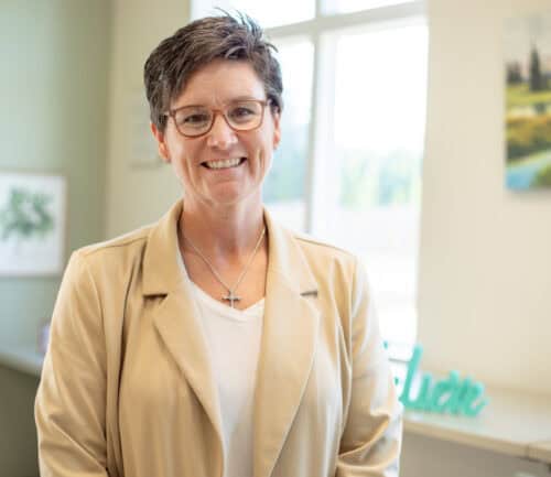 Julie Manuel smiling at camera in group therapy room