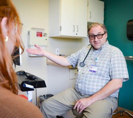 Jason Schofield talking about medications with a patient