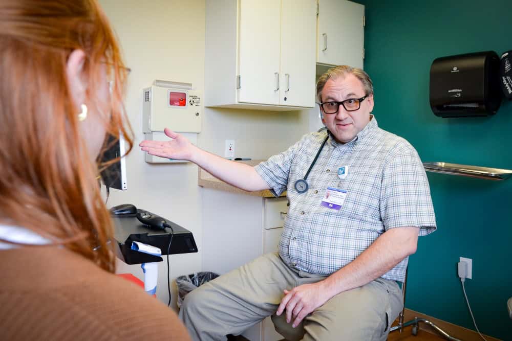 Jason Schofield talking about medications with a patient