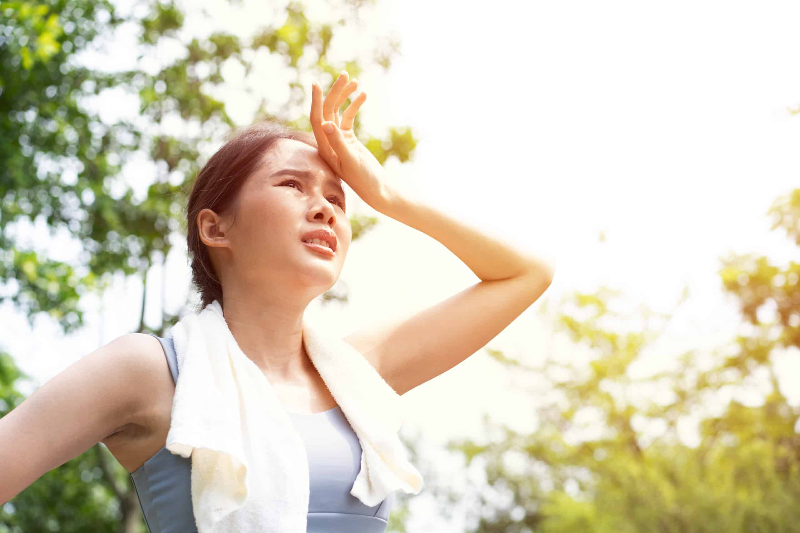 Woman gets tired while exercising in the heat