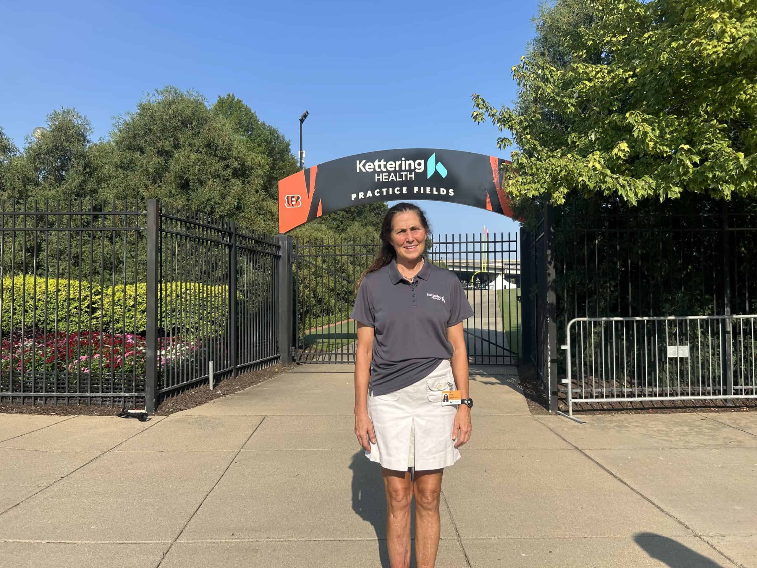 Dr. Cindy Cassell in front of practice fields