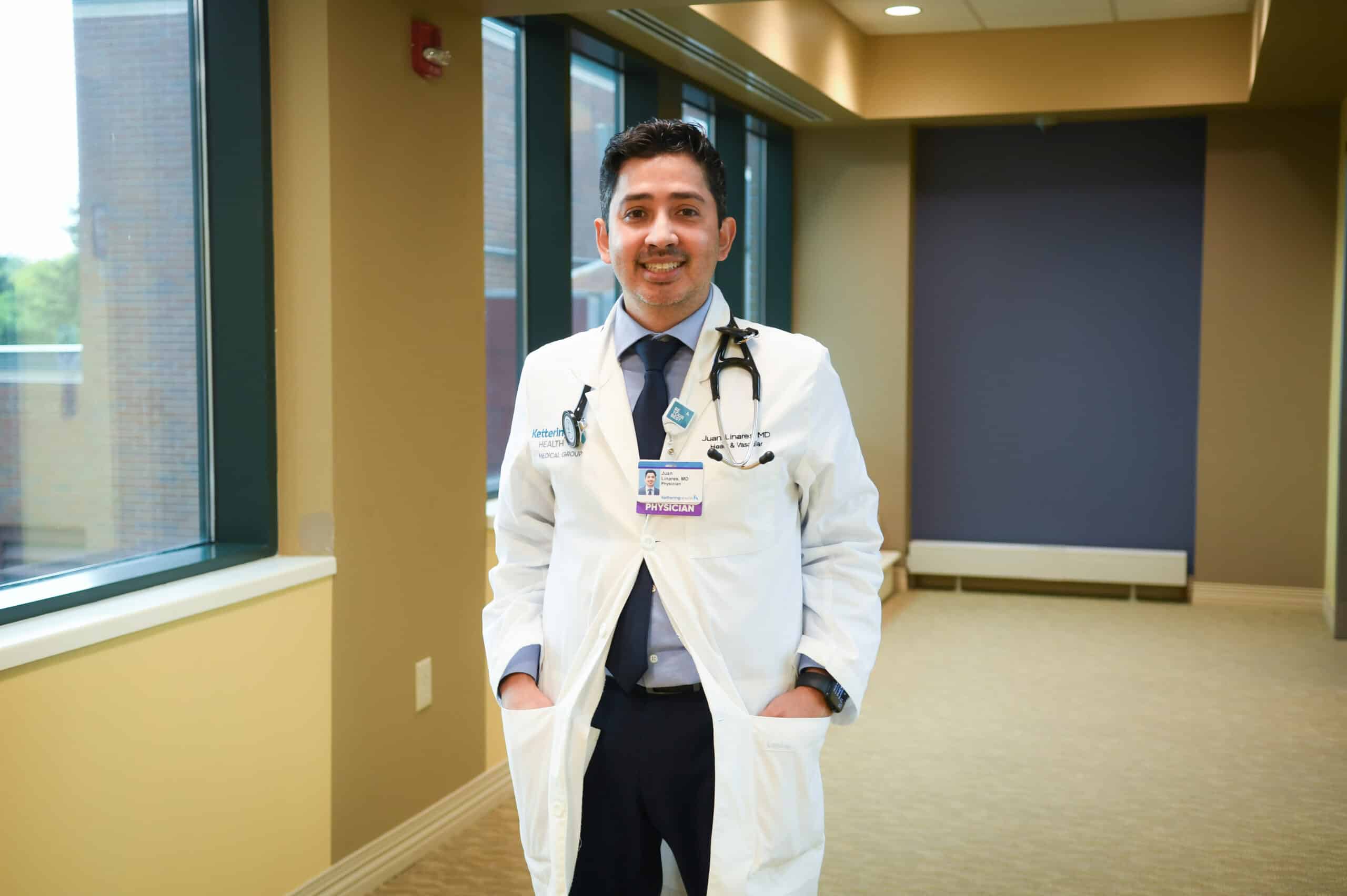 Dr. Juan Linares smiling at camera in hallway