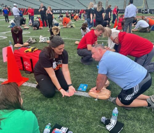 Woman learning CPR at Save the Dey event
