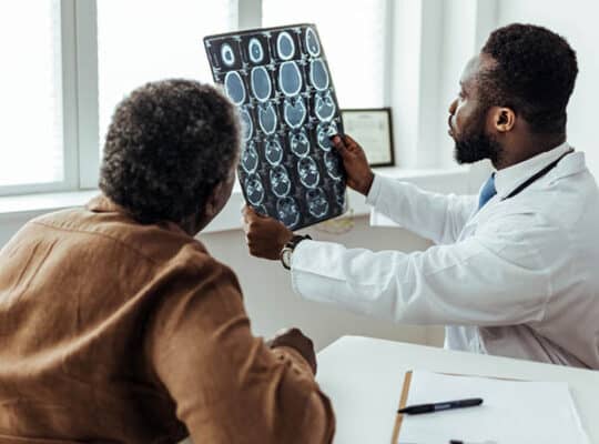 patient and doctor looking at CT results