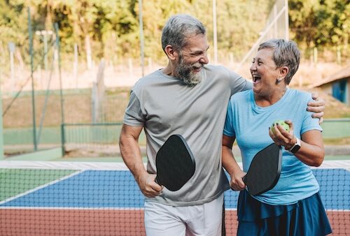 Senior couple playing pickleball
