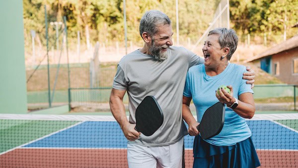 Senior couple playing pickleball