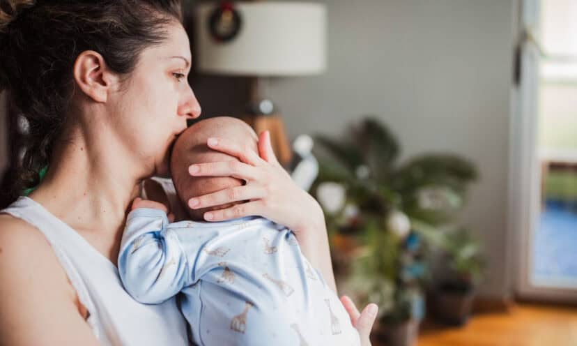 Woman kissing her baby's head