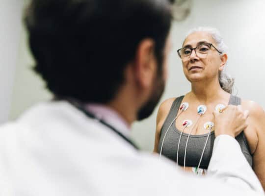Patient talking with her doctor during a cardiopulmonary stress test on a hospital
